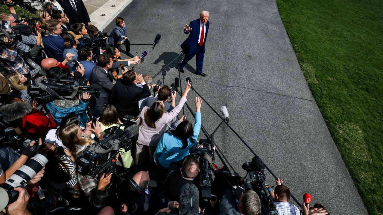President Donald Trump talks to reporters before boarding Marine One at the White House on Thursday.