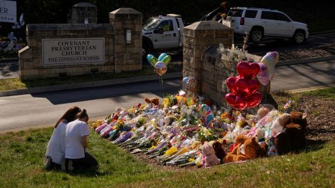 A vehicle is towed from the property as community members pray while visiting a memorial at the school entrance after a deadly shooting at the Covenant School in Nashville, Tennessee, U.S. March 29, 2023. REUTERS/Cheney Orr