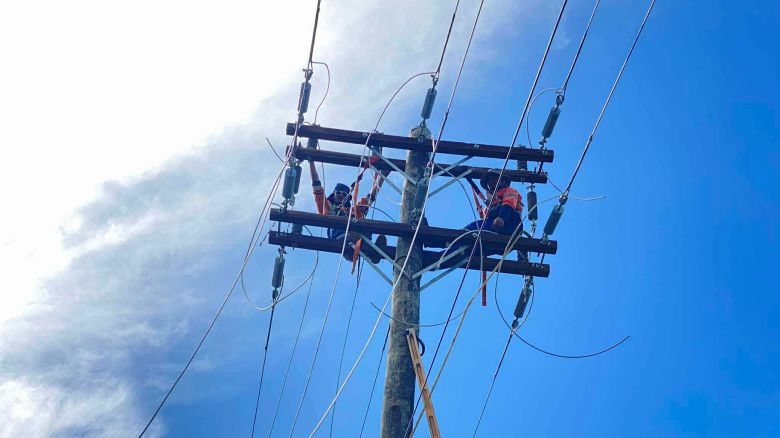 Power company employees work to restore electricity after a storm hit Samoa in March.