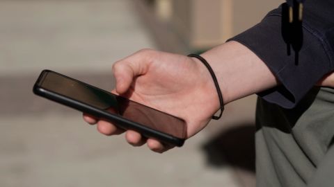 A student uses their cellphone outside of Wakefield High School in Arlington, Virginia.
