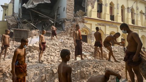 TOPSHOT - Buddhist monks stand on rubble as they clear up debris at the damaged Thahtay Kyaung Monastery in Mandalay on April 1, 2025, four days after a major earthquake struck central Myanmar. Four days after the shallow 7.7-magnitude earthquake that killed more than 2,000 people, many people in Myanmar are still sleeping outdoors, either unable to return to ruined homes or afraid of further aftershocks. (Photo by Sai Aung MAIN / AFP) (Photo by SAI AUNG MAIN/AFP via Getty Images)          