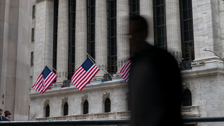 People walk by the New York Stock Exchange (NYSE) before the Closing Bell and the start of President Donald Trump's news conference on tariffs on April 02, 2025 in New York City. In the 4pm announcement, Trump unveiled new tariffs on foreign countries.